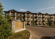 Thumbnail 1 of 31 - an apartment building with a sign and trees in the foreground