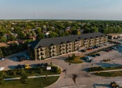 Thumbnail 2 of 31 - an aerial view of a large apartment complex with a parking lot and trees