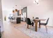 Thumbnail 44 of 44 - A modern kitchen with a dining table and chairs.