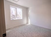 Thumbnail 9 of 44 - A room with a window and a carpeted floor.