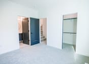 Thumbnail 14 of 44 - A room with a blue door and a white wall.