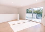 Thumbnail 3 of 44 - A room with a large window and wooden flooring.