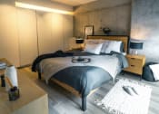 Thumbnail 21 of 31 - a bedroom with a bed and a dresser
