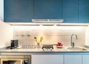 Thumbnail 30 of 31 - a kitchen with blue cabinets and a sink