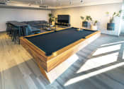 Thumbnail 11 of 31 - a pool table in the center of a room in a living room