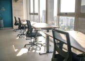 Thumbnail 14 of 31 - tables and chairs in an empty office meeting room with windows
