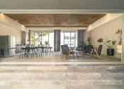 Thumbnail 8 of 31 - a living room with a table and chairs and a kitchen