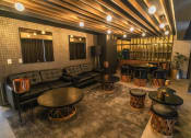 Thumbnail 10 of 31 - a lobby with couches and tables and a bar