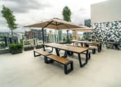 Thumbnail 6 of 31 - a large terrace with tables and umbrellas on the top of a building