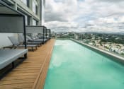 Thumbnail 4 of 31 - a view of a city from an infinity pool on a skyscraper overlooking a city