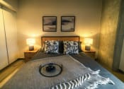 Thumbnail 23 of 31 - a bedroom with a bed and two lamps and two pictures on the wall