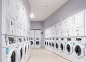 Thumbnail 7 of 12 - a row of washing machines in a laundromat