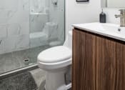 Thumbnail 9 of 12 - a bathroom with a toilet sink and shower in a 555 waverly unit
