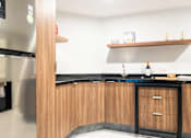 Thumbnail 11 of 12 - a kitchen with wooden cabinets and stainless steel appliances