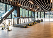 Thumbnail 1 of 12 - a row of treadmills and elliptical trainers in a gym