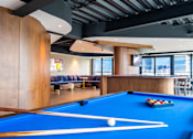 Thumbnail 3 of 12 - a pool table and bar in a lounge area