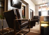 Thumbnail 23 of 53 - a living room with leather chairs and a television