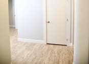 Thumbnail 21 of 53 - an empty hallway with white walls and a door to a closet
