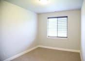 Thumbnail 27 of 53 - a room with a window and white walls and carpet