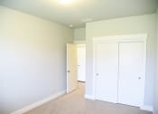 Thumbnail 30 of 53 - a bedroom with white walls and a closet