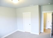 Thumbnail 29 of 53 - an empty room with white walls and a door to a closet