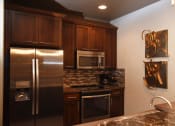Thumbnail 39 of 53 - a kitchen with stainless steel appliances and granite counter tops