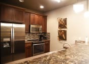 Thumbnail 35 of 53 - a large kitchen with stainless steel appliances and granite counter tops