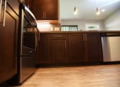 Thumbnail 41 of 53 - a kitchen with wooden cabinets and stainless steel appliances