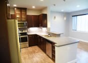 Thumbnail 36 of 53 - a kitchen with a large island and a refrigerator