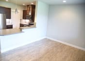 Thumbnail 40 of 53 - an empty kitchen and living room with wood flooring