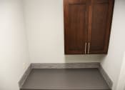 Thumbnail 44 of 53 - an empty room with a cabinet on the wall and a gray floor