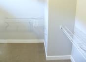Thumbnail 51 of 53 - a walk in closet with shelves and a mirrored closet door