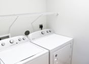 Thumbnail 46 of 53 - a washer and dryer in a room with white walls and wood floors