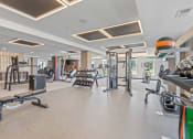 Thumbnail 38 of 59 - a spacious fitness room with cardio equipment and weights