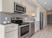 Thumbnail 47 of 59 - a kitchen with white cabinets and stainless steel appliances