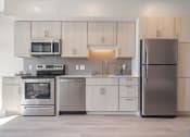 Thumbnail 48 of 59 - a kitchen with white cabinets and stainless steel appliances