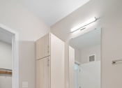 Thumbnail 52 of 59 - a bathroom with white cabinets and a blue rug