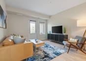 Thumbnail 12 of 59 - a living room with white walls and hardwood flooring