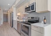 Thumbnail 57 of 59 - a kitchen with white cabinets and stainless steel appliances