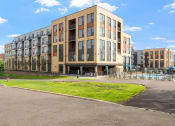 Thumbnail 21 of 59 - a building with a pool in front of it