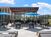 Thumbnail 32 of 59 - an outdoor patio with tables and umbrellas