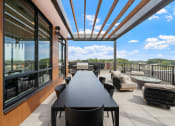 Thumbnail 10 of 59 - a large dining table with chairs on a patio with a fire pit and a view of the