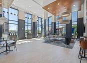 Thumbnail 1 of 59 - a large room with a couch tables and chairs and a large wall of windows