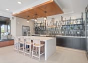 Thumbnail 2 of 59 - a kitchen with a long island with a white countertop
