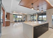 Thumbnail 3 of 59 - a kitchen with a large center island with a sink and a refrigerator