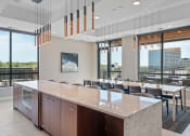 Thumbnail 43 of 59 - a kitchen with a long island and a long table with chairs