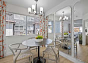 Thumbnail 10 of 63 - a dining area with a table and chairs and a large window