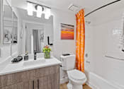 Thumbnail 19 of 63 - a bathroom with a toilet sink and tub and a shower