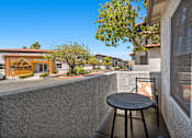 Thumbnail 44 of 63 - a patio with a table and a chair on a balcony
