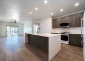 Thumbnail 6 of 49 - a kitchen with brown cabinets and stainless steel appliances at Slate Scottsdale, lofts for rent Phoenix.